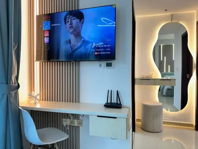 a room with a desk with a tv on a wall at Minimalist Studio with Amazings Marina Canal Views in Dubai