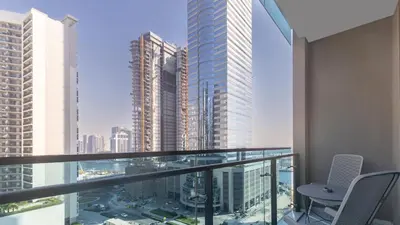 a balcony with chairs and a view of a city at Modern 2BR Apartment in Merano Tower, Business Bay in Dubai