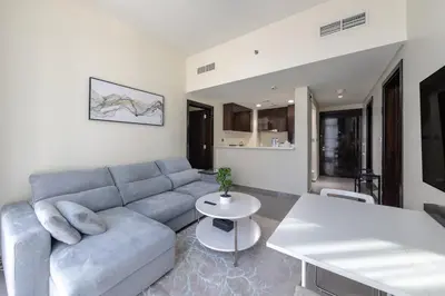 a living room with a couch and a table at Modern 2BR Apartment in Merano Tower, Business Bay in Dubai
