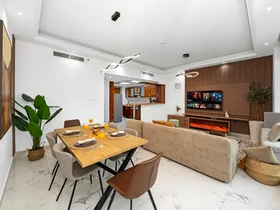 a living room with a table and a couch at Centric Flat w Marina View, Ideal Beach Stay Big Terrace Sleep 9 in Dubai