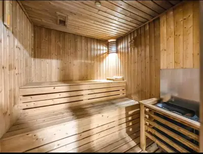 a wooden sauna with a bench in the middle at Centric Flat w Marina View, Ideal Beach Stay Big Terrace Sleep 9 in Dubai