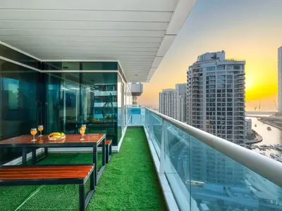 a balcony with a table and a view of a city at Centric Flat w Marina View, Ideal Beach Stay Big Terrace Sleep 9 in Dubai