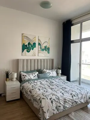 a bedroom with a bed and two paintings on the wall at Specious 1 bd close to Sea Jumeirah in Dubai