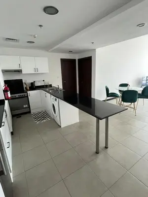 a kitchen with a table and chairs in a room at Specious 1 bd close to Sea Jumeirah in Dubai