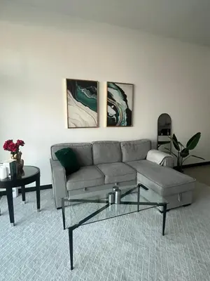 a living room with a couch and a table at Specious 1 bd close to Sea Jumeirah in Dubai