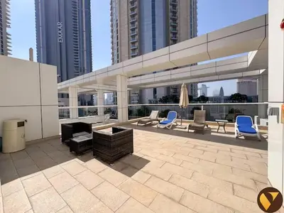a patio with chairs and a couch and chairs at Vogue Downtown Mon Reve near Burj Khalifa and Dubai Mall, Two Bedroom plus kids room Apartment with Balcony and Access to all Amenities in Dubai