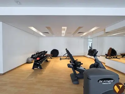 a gym with treadmills and exercise bikes in a room at Vogue Downtown Mon Reve near Burj Khalifa and Dubai Mall, Two Bedroom plus kids room Apartment with Balcony and Access to all Amenities in Dubai