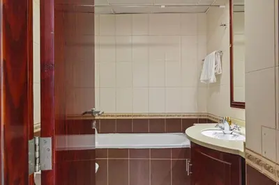a bathroom with a tub and a sink at Cozy 1BR with gym & pool in heart of Marina - Opal Tower in Dubai