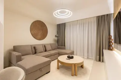 a living room with a couch and a table at Spacious 2BR with Burj Khalifa View in Downtown Dubai in Dubai