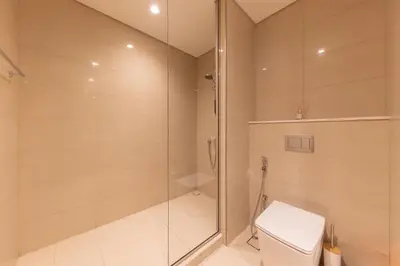 a bathroom with a shower and a toilet at Spacious 2BR with Burj Khalifa View in Downtown Dubai in Dubai