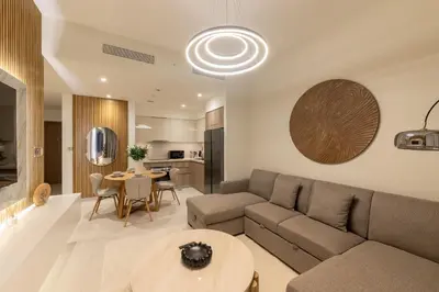 a living room with a couch and a table at Spacious 2BR with Burj Khalifa View in Downtown Dubai in Dubai