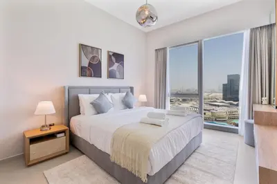 a bedroom with a large bed and a large window at 2Bed with spectacular Burj Khalifa & fountain view in Dubai