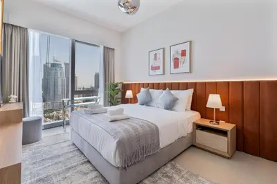 a bedroom with a large bed and a large window at 2Bed with spectacular Burj Khalifa & fountain view in Dubai