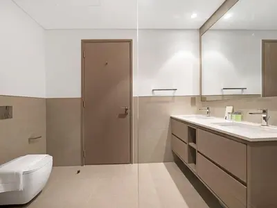a bathroom with a toilet and a sink and a mirror at 2BR balcony Downtown with Burj Khalifa and Fountain View in Dubai