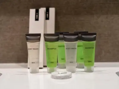 a group of four bottles of hair products on a table at 2BR balcony Downtown with Burj Khalifa and Fountain View in Dubai
