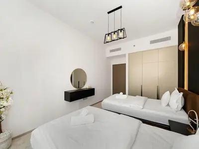a bedroom with two beds and a mirror at 2BR balcony Downtown with Burj Khalifa and Fountain View in Dubai