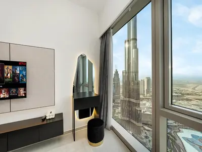 a room with a large window with a view of a city at 2BR balcony Downtown with Burj Khalifa and Fountain View in Dubai