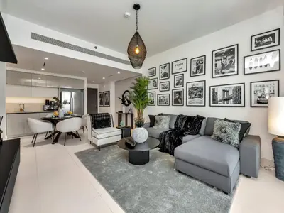 a living room with a couch and a table at Stylish 2 bedroom - Marina Views - Private Beach in Dubai