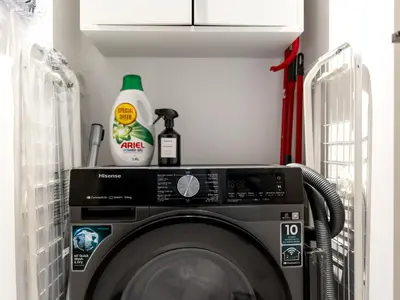 a room with a washing machine in a laundry room at Stylish 2 bedroom - Marina Views - Private Beach in Dubai