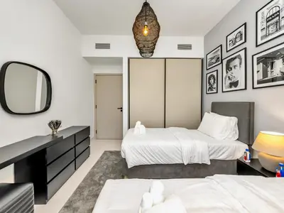 a bedroom with two beds and a mirror at Stylish 2 bedroom - Marina Views - Private Beach in Dubai