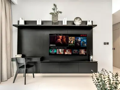 a black entertainment center with a flat screen tv at Stylish 2 bedroom - Marina Views - Private Beach in Dubai