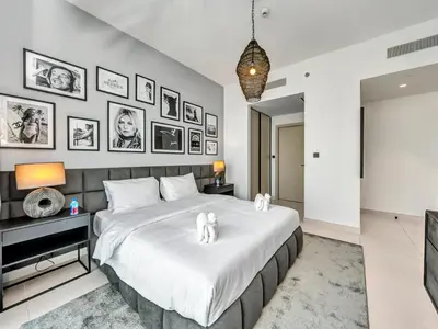 a bedroom with a large bed with white sheets at Stylish 2 bedroom - Marina Views - Private Beach in Dubai