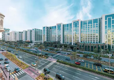 a city with a street with traffic and buildings at Cozy 2 Br Heart of Palm Jumeirah in Dubai