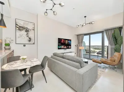 a living room with a couch and a table at Golf View Modern Comfort Perfect for 3 Guests in Dubai