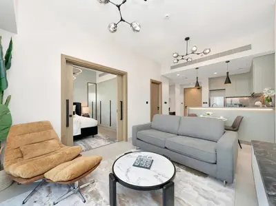 a living room with a couch and a table at Golf View Modern Comfort Perfect for 3 Guests in Dubai
