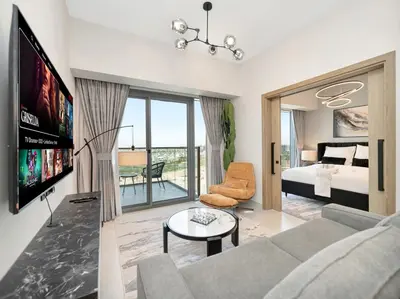 a living room with a couch and a tv and a bed at Golf View Modern Comfort Perfect for 3 Guests in Dubai
