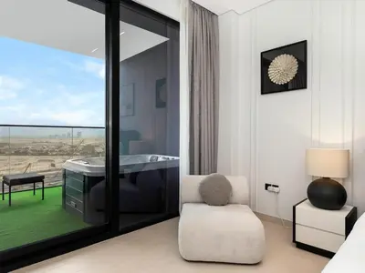 a room with a desk and a chair and a window at Modern Studio with Jacuzzi and Premium Amenities in Dubai