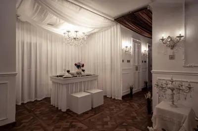 a white room with a table and a chandelier at Luxury Apartments at Grande with Burj Khalifa & Fountain View Walk to Dubai Mall, Private Cinema in Dubai