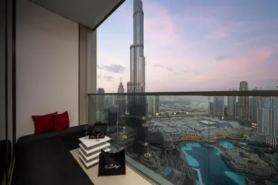 a room with a view of a skyscraper at Luxury Apartments at Grande with Burj Khalifa & Fountain View Walk to Dubai Mall, Private Cinema in Dubai