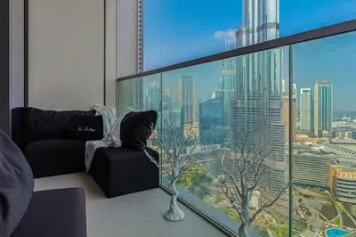 a living room with a view of a city at Luxury Apartments at Grande with Burj Khalifa & Fountain View Walk to Dubai Mall, Private Cinema in Dubai