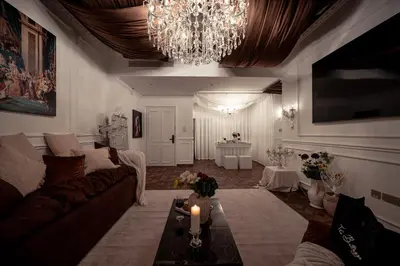 a living room with a couch and a chandelier at Luxury Apartments at Grande with Burj Khalifa & Fountain View Walk to Dubai Mall, Private Cinema in Dubai