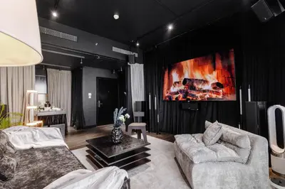 a living room with a couch and a fireplace at Luxury Apartments at Grande with Burj Khalifa & Fountain View Walk to Dubai Mall, Private Cinema in Dubai