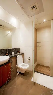 a bathroom with a toilet and a sink and a shower at Modern studio in Business Bay- 5 min to Dubai Mall in Dubai