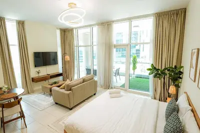 a large living room with a bed and a couch at Modern studio in Business Bay- 5 min to Dubai Mall in Dubai