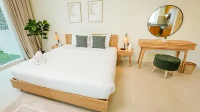 a bedroom with a large white bed and a mirror at Modern studio in Business Bay- 5 min to Dubai Mall in Dubai
