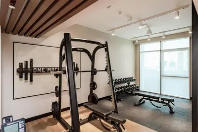 a gym with two tread machines in a room at Homey 1BR apartment in Creek Harbour in Dubai