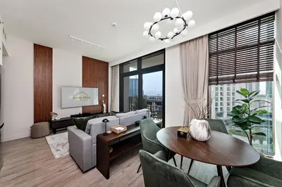a living room with a couch and a table at Homey 1BR apartment in Creek Harbour in Dubai