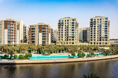 a city with tall buildings and a body of water at Homey 1BR apartment in Creek Harbour in Dubai
