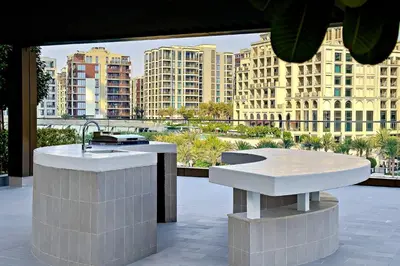 a kitchen with a sink and a view of buildings at Homey 1BR apartment in Creek Harbour in Dubai