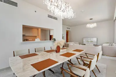 a dining room with a table and chairs at Commodious 3BR Apartment Canal View Creek Harbor in Dubai
