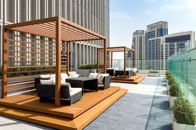 a rooftop patio with a gazebo on a building at Commodious 3BR Apartment Canal View Creek Harbor in Dubai
