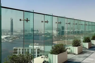 a glass building with a view of a city at Commodious 3BR Apartment Canal View Creek Harbor in Dubai