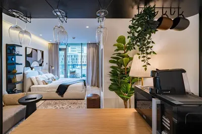 a bedroom with a bed and a living room at Smart Studio in Business Bay Near Burj Khalifa in Dubai