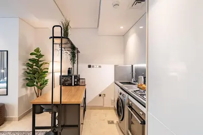 a kitchen with a counter and a stove top oven at Smart Studio in Business Bay Near Burj Khalifa in Dubai