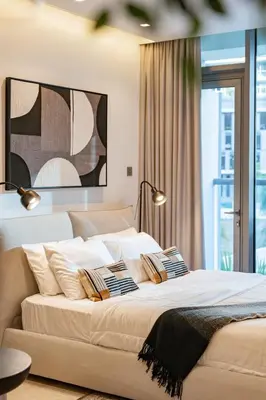 a bedroom with a large white bed with pillows at Smart Studio in Business Bay Near Burj Khalifa in Dubai