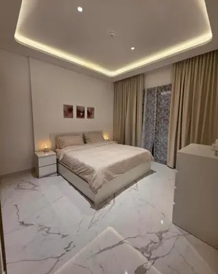 a bedroom with a bed and a marble floor at 10 min to Burj Khalifa 1BR in Hotel-style building Luxury Stay in Dubai
